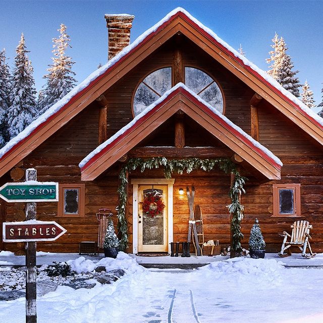 santa claus log cabin in snowy north pole setting with sign pointing to top shop and stables