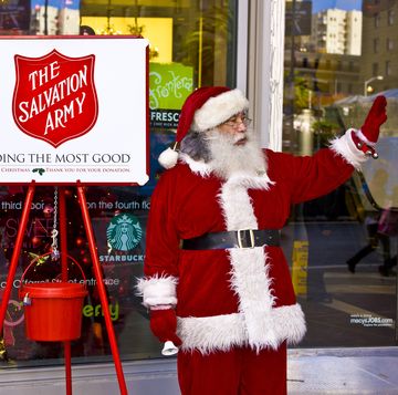 person dressed as santa claus ringing bell for salvation army donations