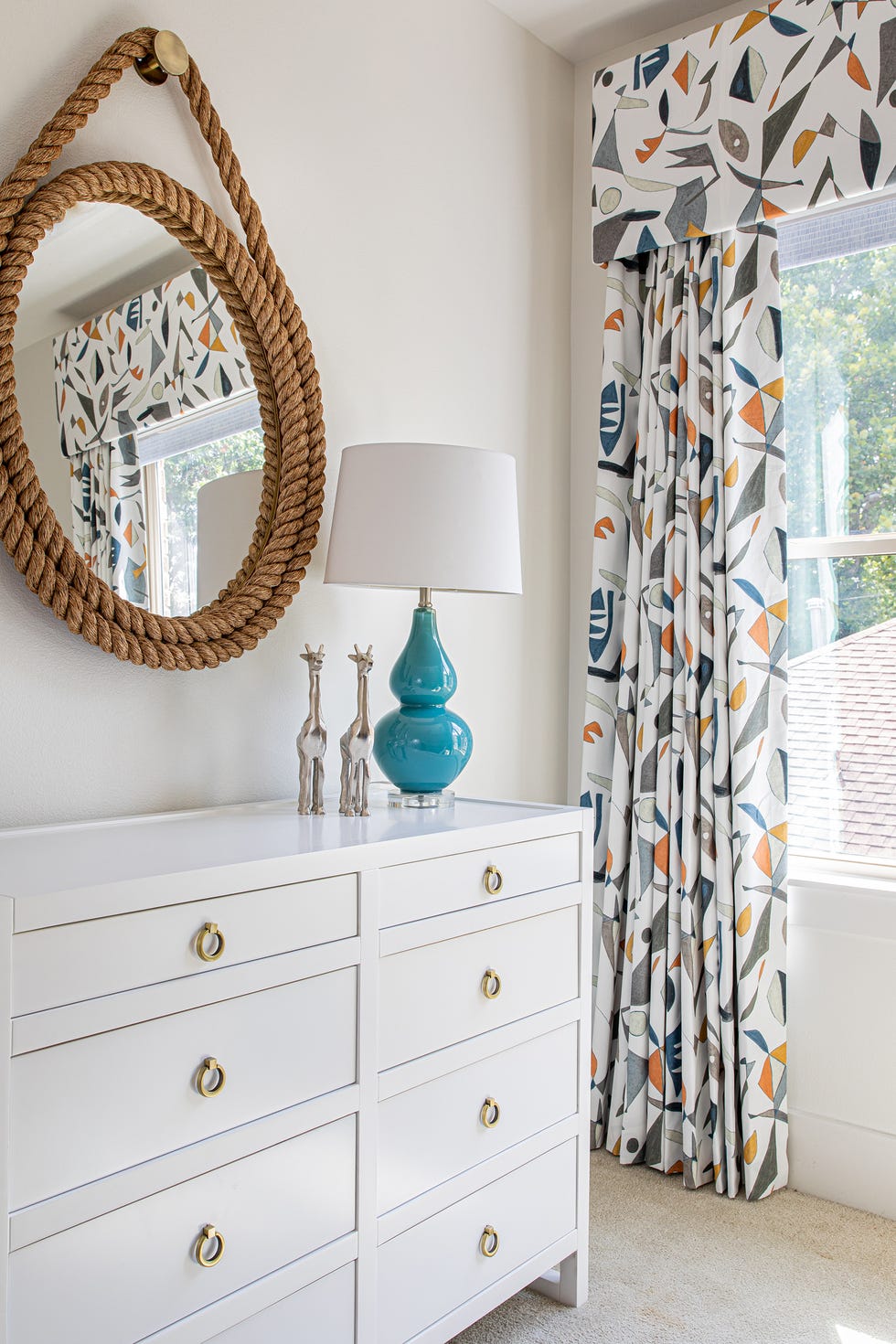 bedroom with patterned wallpaper and white dresser