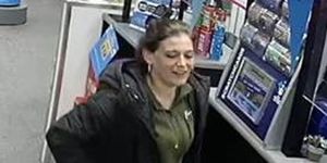missing woman sarah henshaw shown on cctv in a supermarket by the till she is smiling and wearing a green jumper and black coat