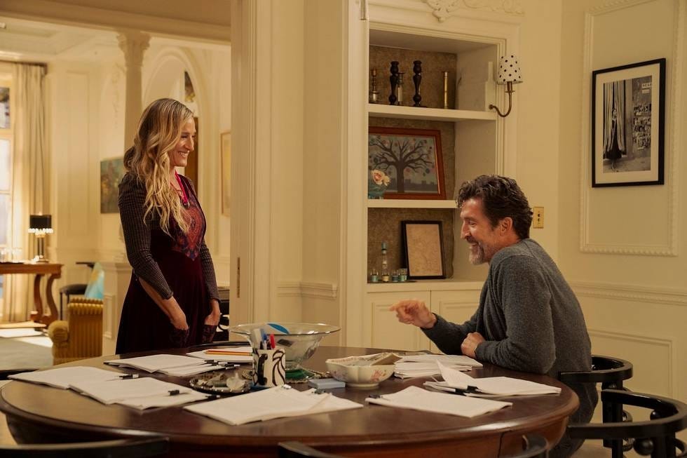 conversation between two individuals at a dining table in a wellfurnished room
