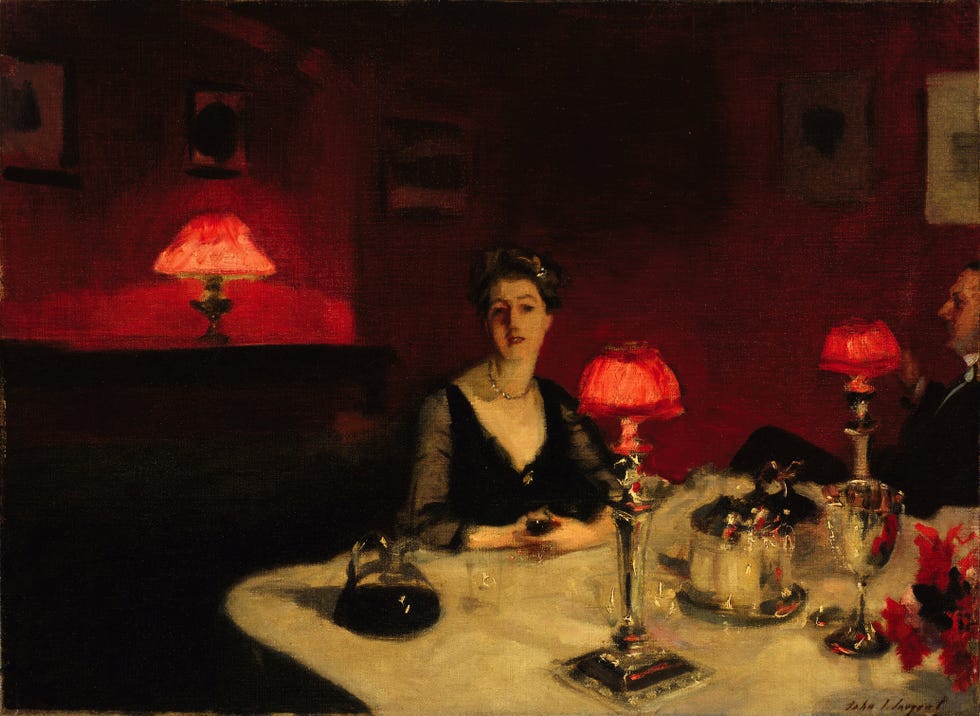 a social dining setting with a table adorned by lamps and elegant tableware