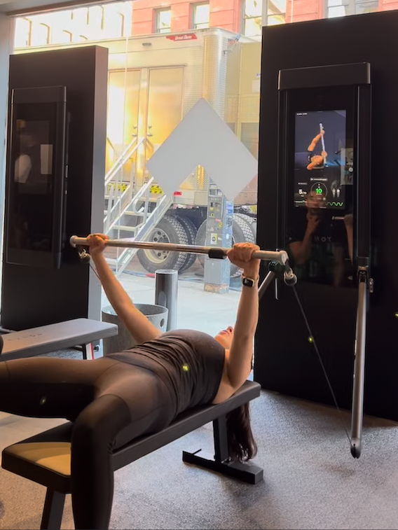 sassos exercising on the tonal 2 with the machine's bench