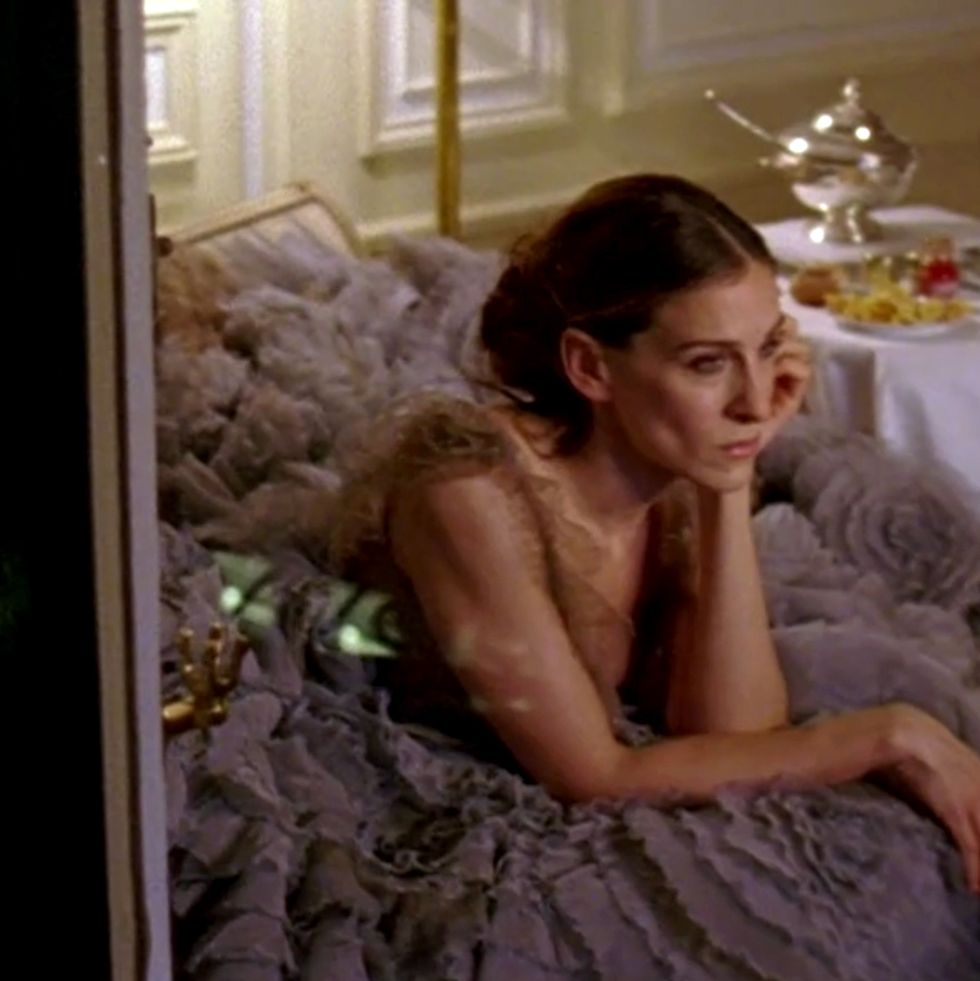 carrie bradshaw sitting in a gown in paris