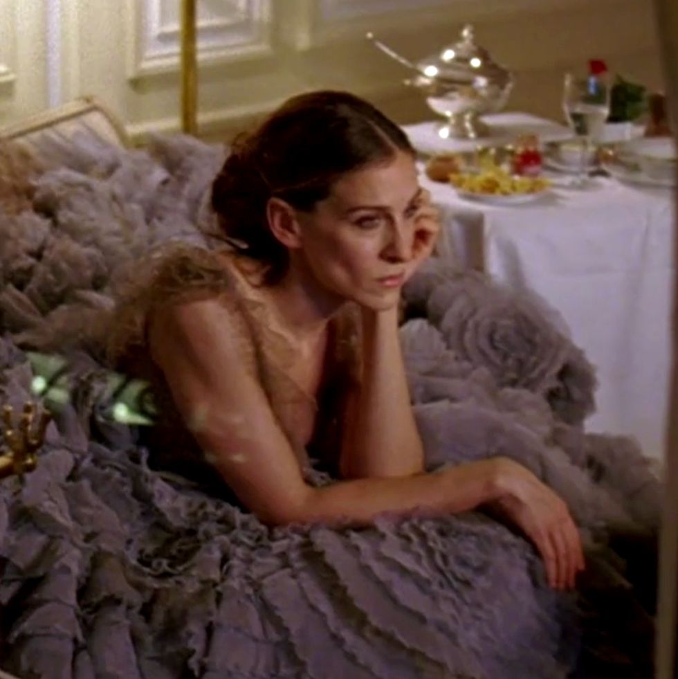 carrie bradshaw sitting in a gown in paris