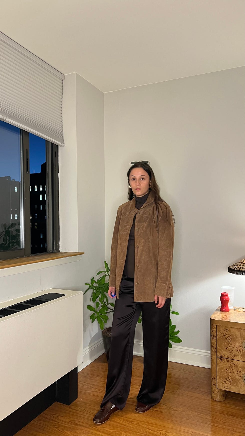 chocolate brown satin pants, leather loafers, and brown turtleneck with suede jacket