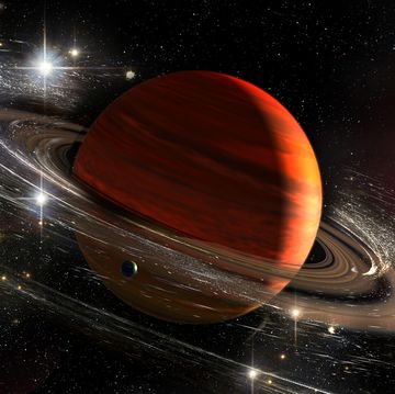 saturn planet with rings in outer space among star dust and srars titan moon seen elements of this image furnished by nasa