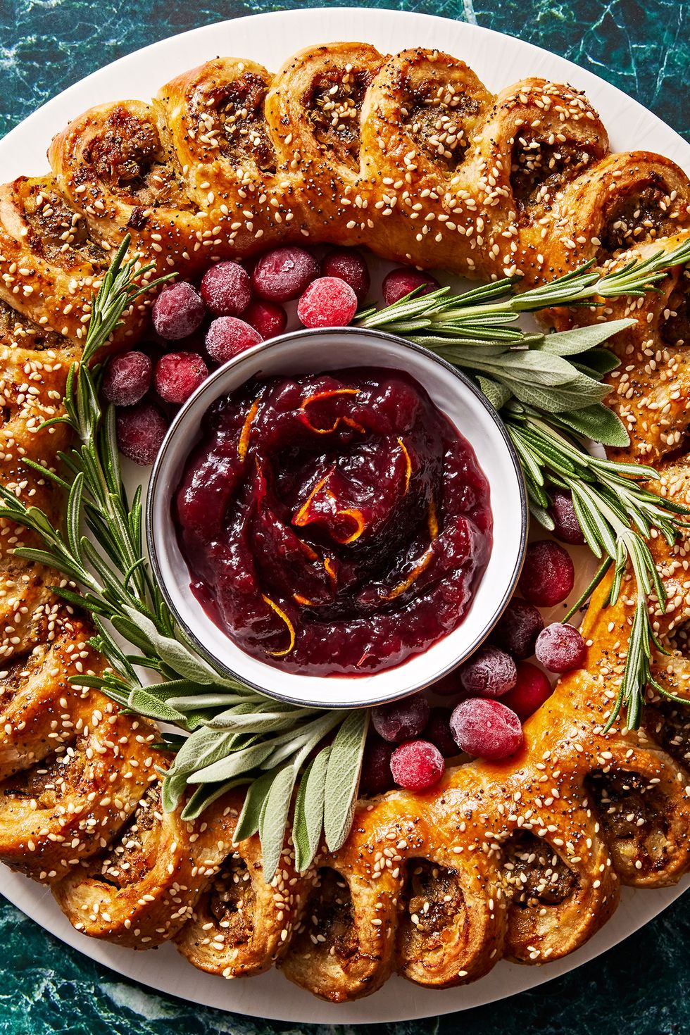 sausage roll wreath with cranberry sauce for dipping