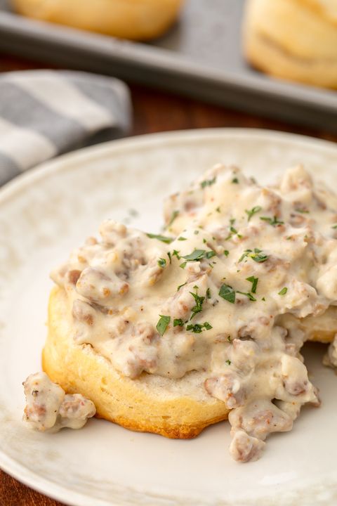 sausage gravy garnished with minced herbs on a piece of bread