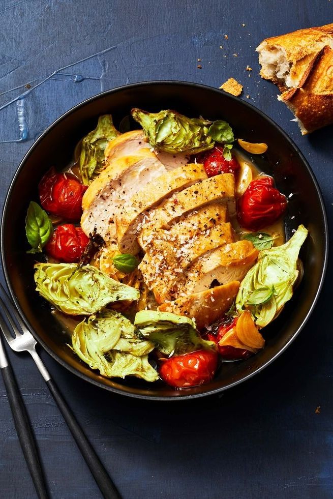 sautéed chicken and tomatoes with roasted artichokes in a bowl