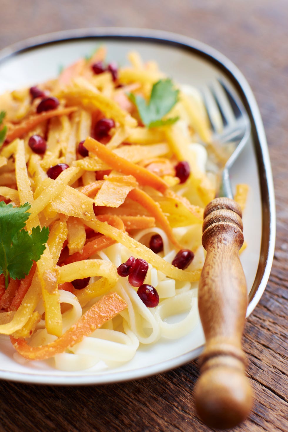 sauteed carrots and rutabaga on pasta with pomegranate sauce