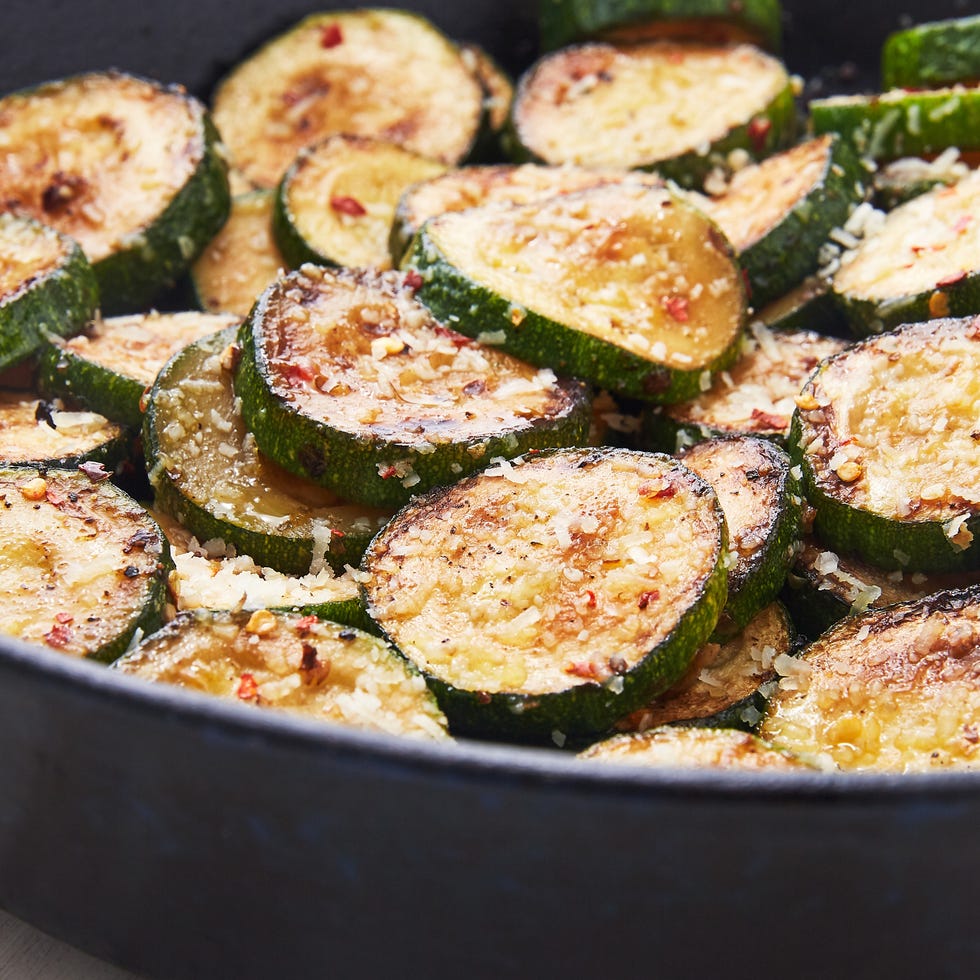 sauteed zucchini in a pan with parmesan