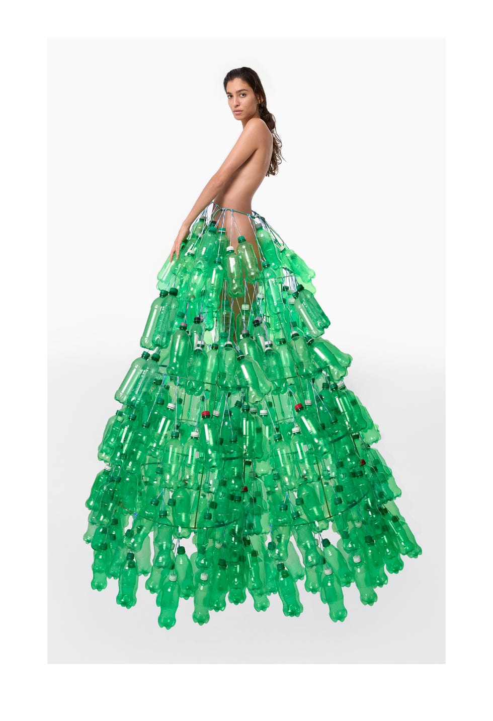 model wearing skirt made of green plastic bottles
