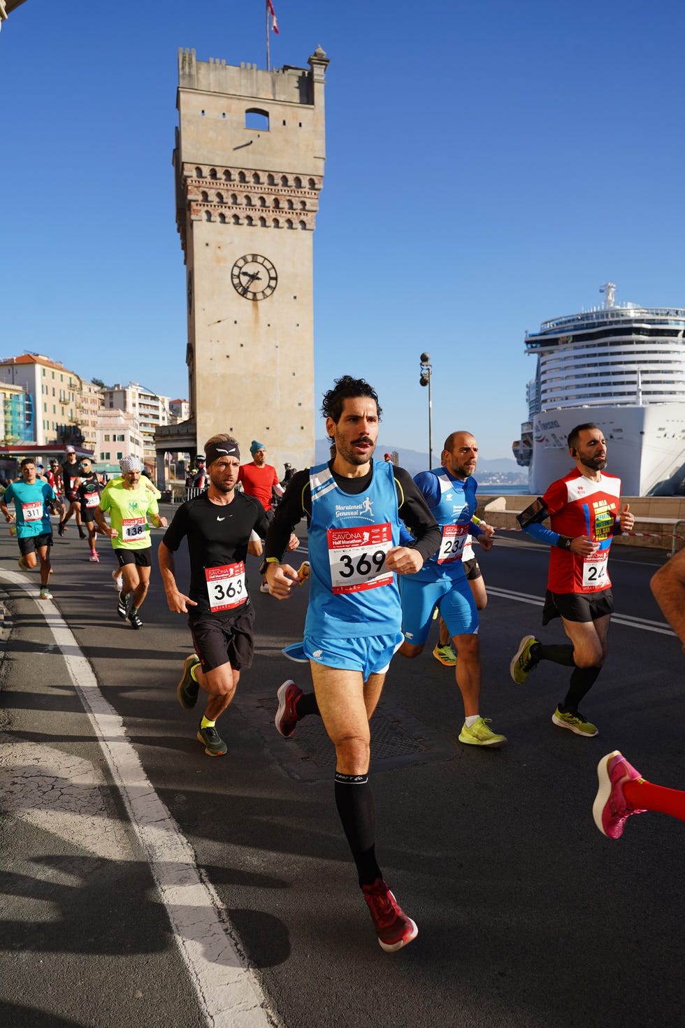 runners participating in a street race near a historic clock tower