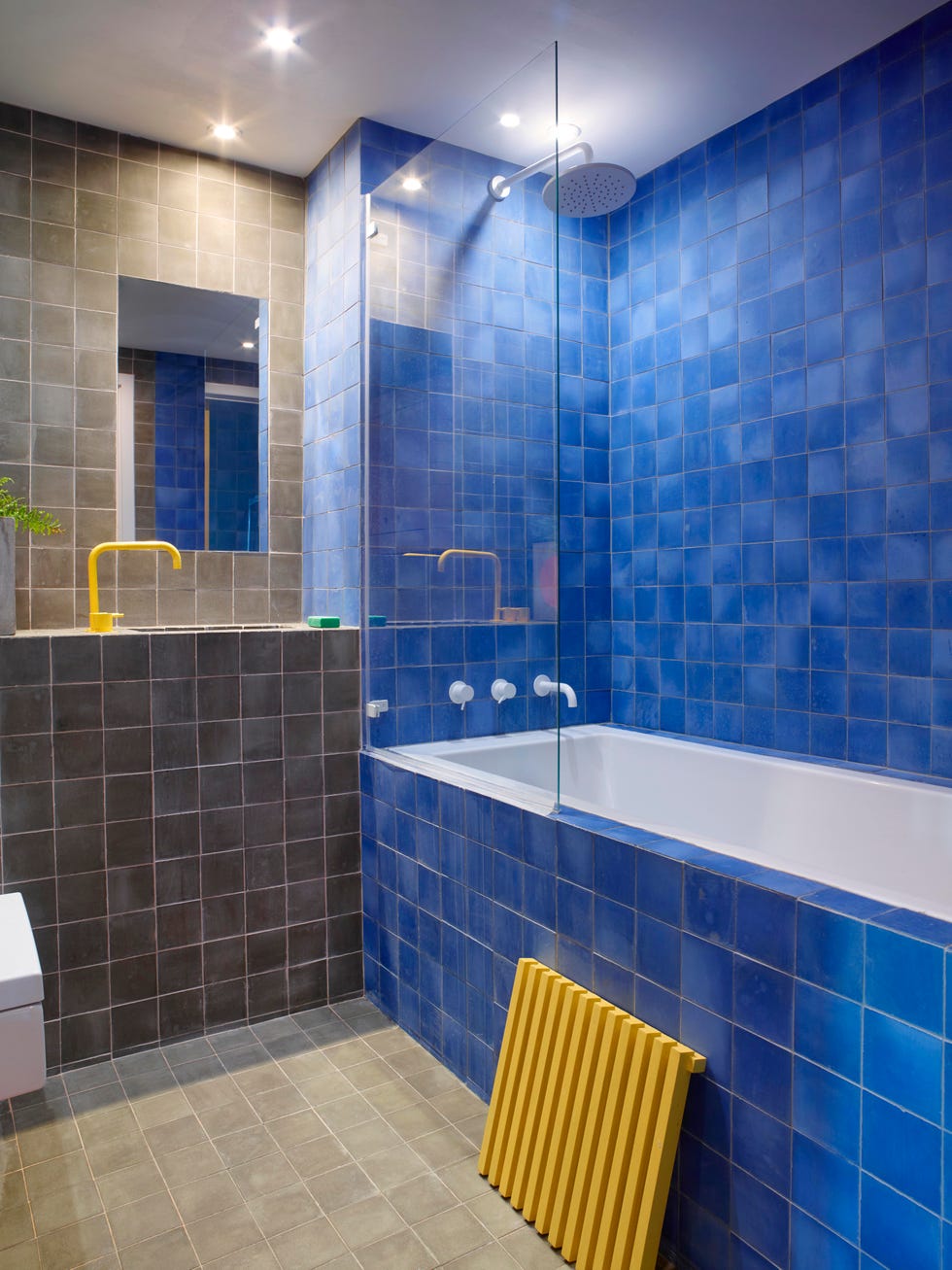 modern bathroom with one grey tile wall and one cobalt blue tile wall