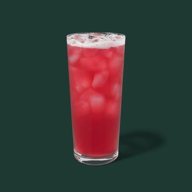 tall glass containing a red beverage with ice cubes