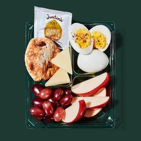 a lunch box with eggs and fruit