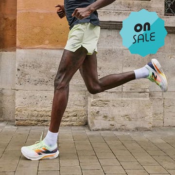 running shoes displayed for sale alongside a runner in action running shoes displayed for sale alongside a runner in action