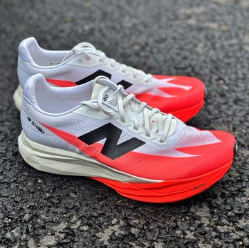 a white and red new balance running shoe on the road a white and red new balance running shoe on the road