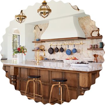 a kitchen with a large chandelier and a bar stool