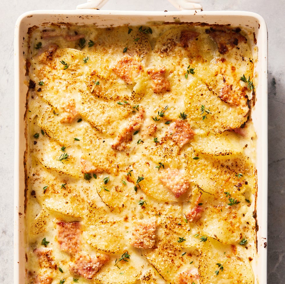 scalloped potatoes and ham in a white casserole dish