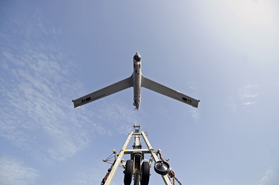 A ScanEagle unmanned aerial vehicle launches from its catapult.