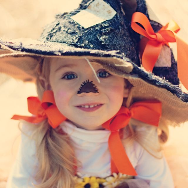 little girl dressed like a scarecrow