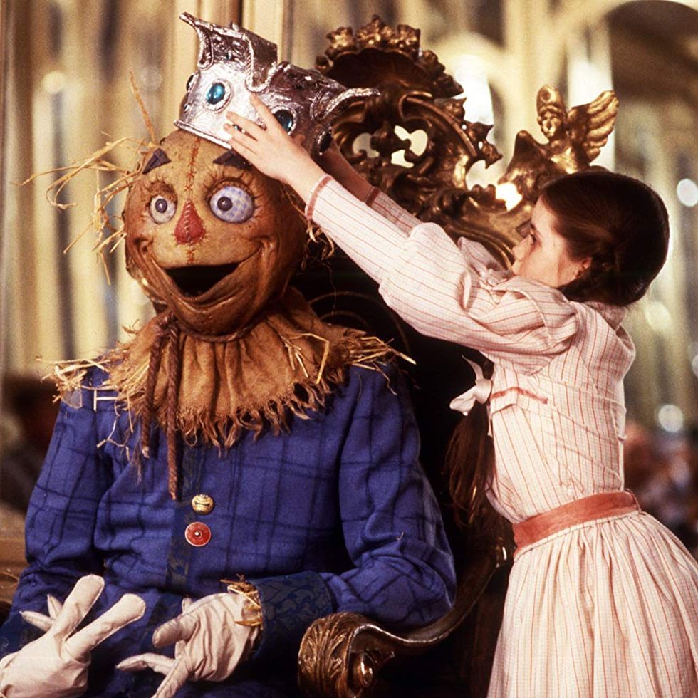 dorothy puts a crown on the scarecrow's head in a scene from 'return to oz,' a good housekeeping pick for best scary movies for kids
