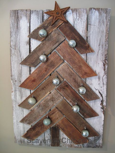 chevron shaped tree made from pallet boards decorated with green vintage christmas balls on top of  white washed boards