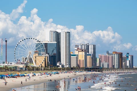 Scenic View Of Beach And Buildings Against Sky scenic view of beach and buildings against sky