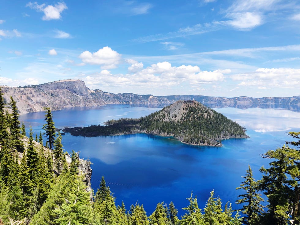 crater lake scenic view of lake by trees against sky