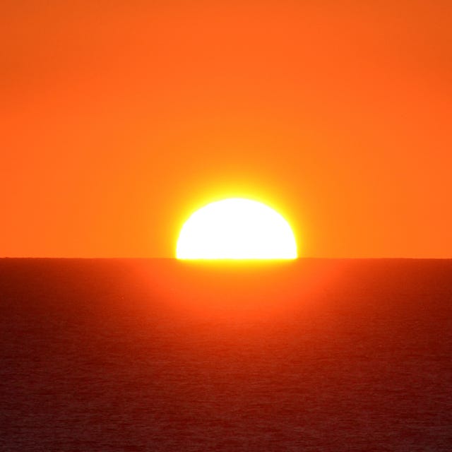 scenic view of sea against orange sky,lissabon,portugal