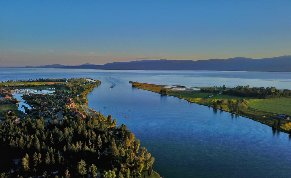 best small lake towns bigfork montana scenic view of sea against sky at sunset