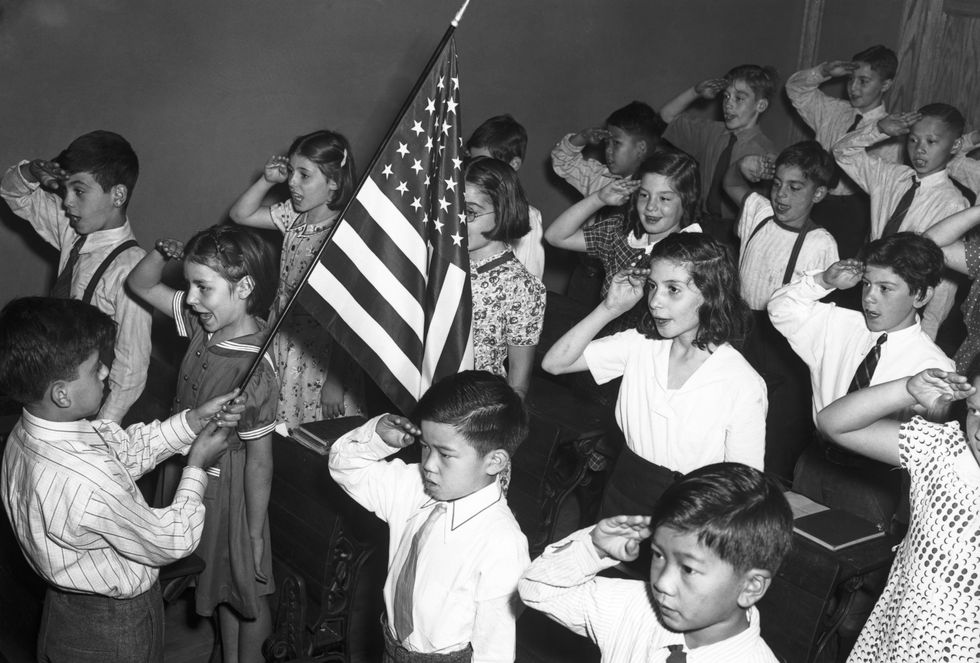 children saluting american flag