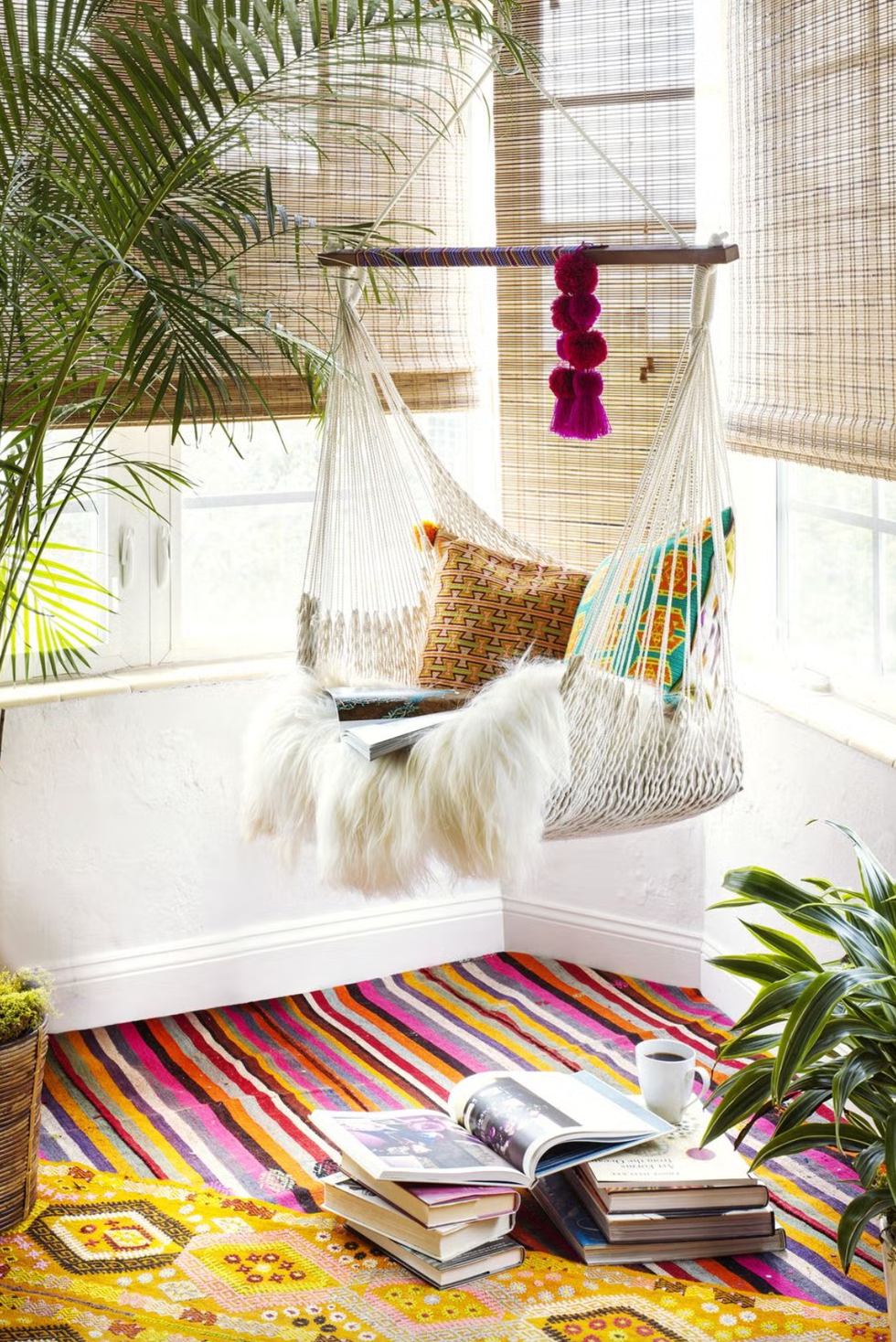 hammock chair with cushions and books in a cozy corner