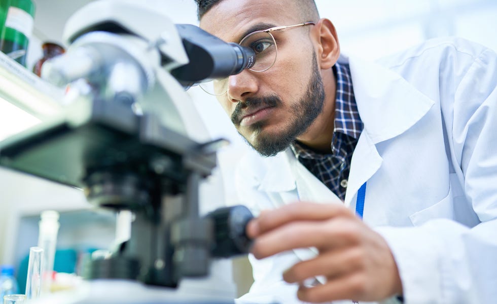 Scientist Using Microscope in Laboratory