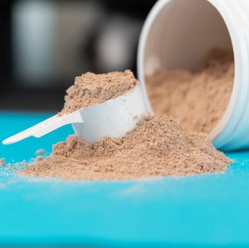 scoop filled with brown or chocolate flavored protein powder