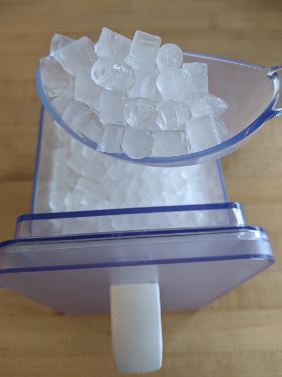 a scoop of nugget ice from the drawer of a nugget ice machine
