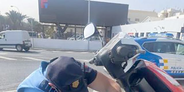 a person in a helmet working on a race car