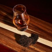 scotch in glencairn glass next to peat