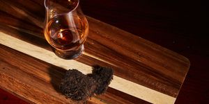 scotch in glencairn glass next to peat