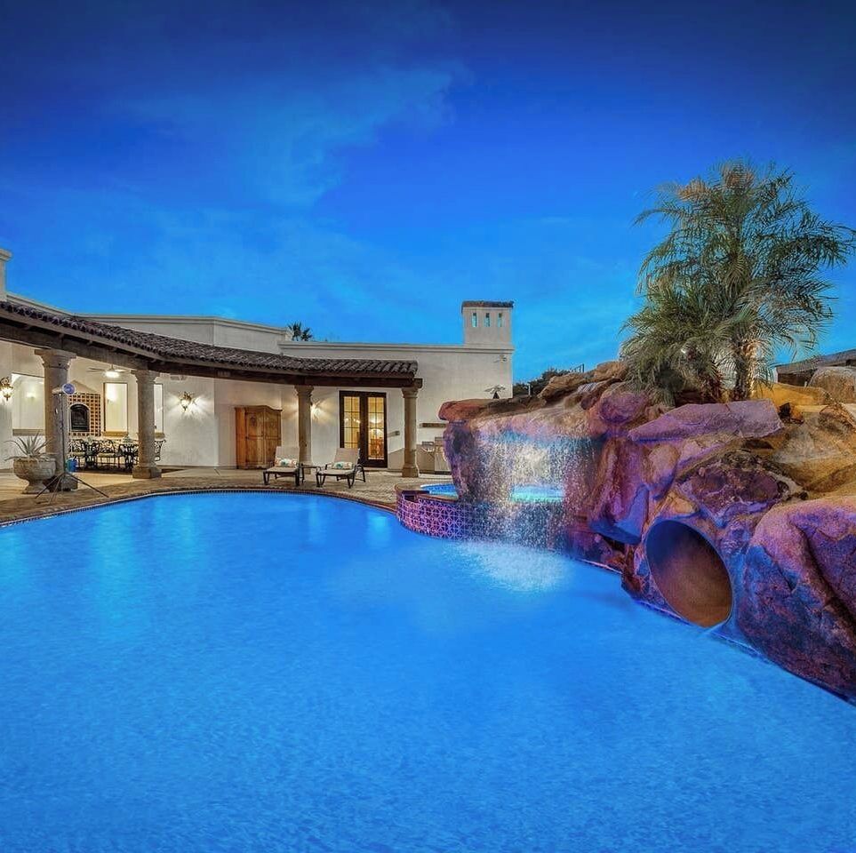a pool in front of a house