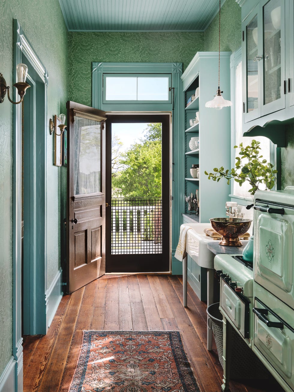 blueish green galley kitchen with vintage stove