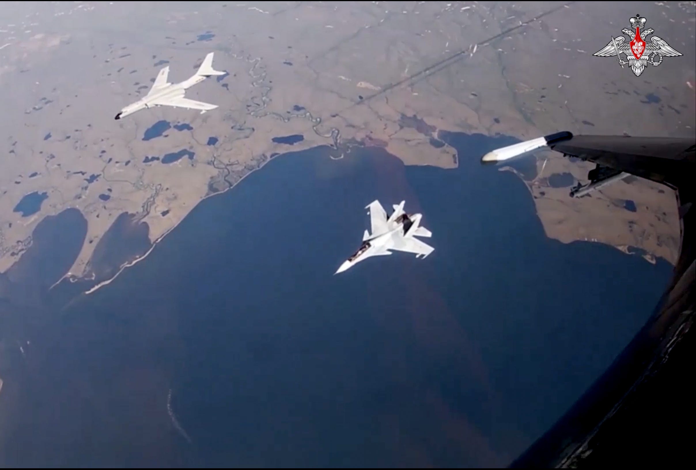 video capture from russian su 35s fighter escorting a chinese plaaf h 6 bomber also escorted by su 30sm fighter