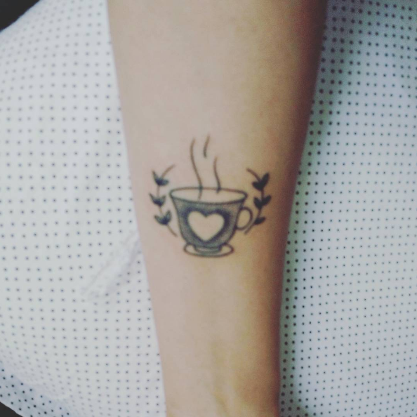 Minimalist croissant and coffee tattoo in fine line