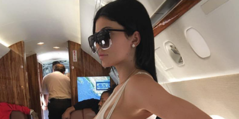 Kylie Jenner Pairs Sheer Bodysuit with Baggy Sweats on Private Jet