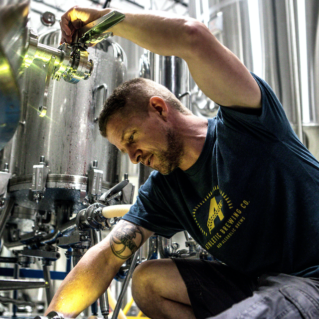 Athletic's head brewer checks the clarity of conditioned beer