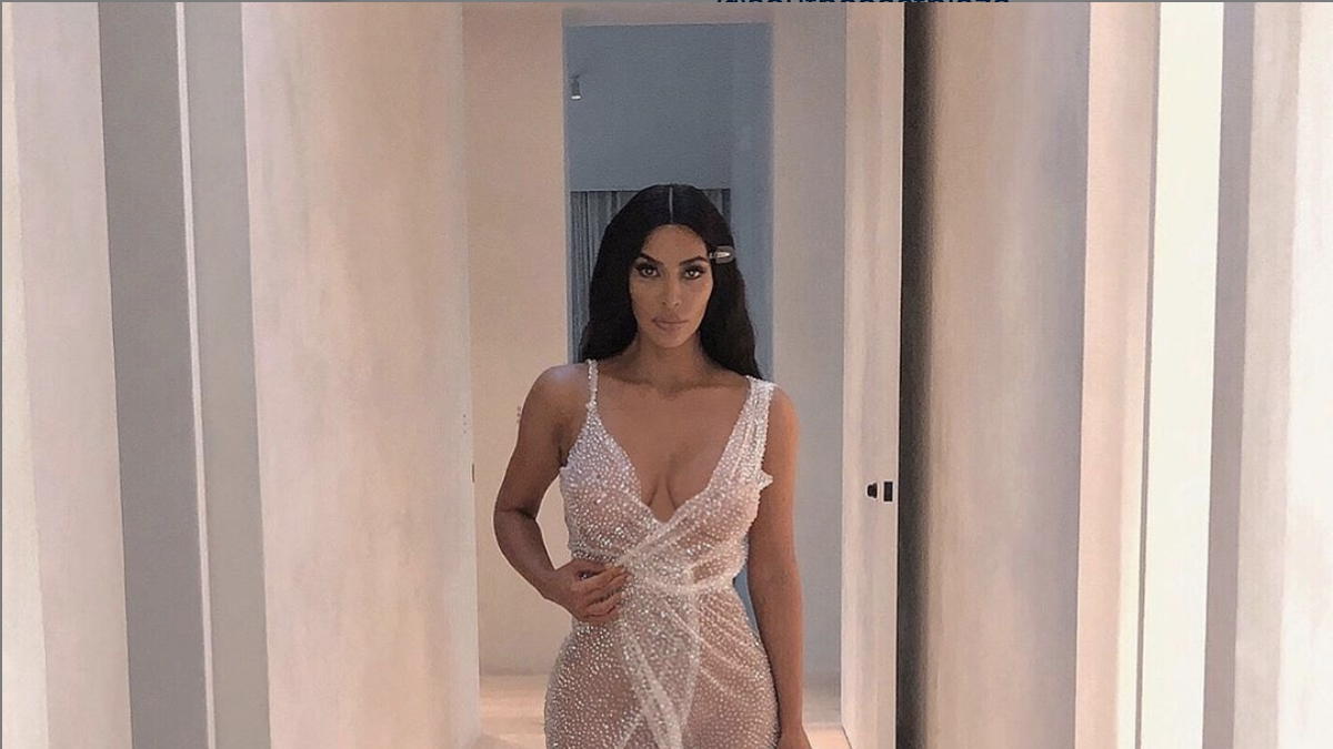 Kim Kardashian glows in NUDE see-through corset dress for new