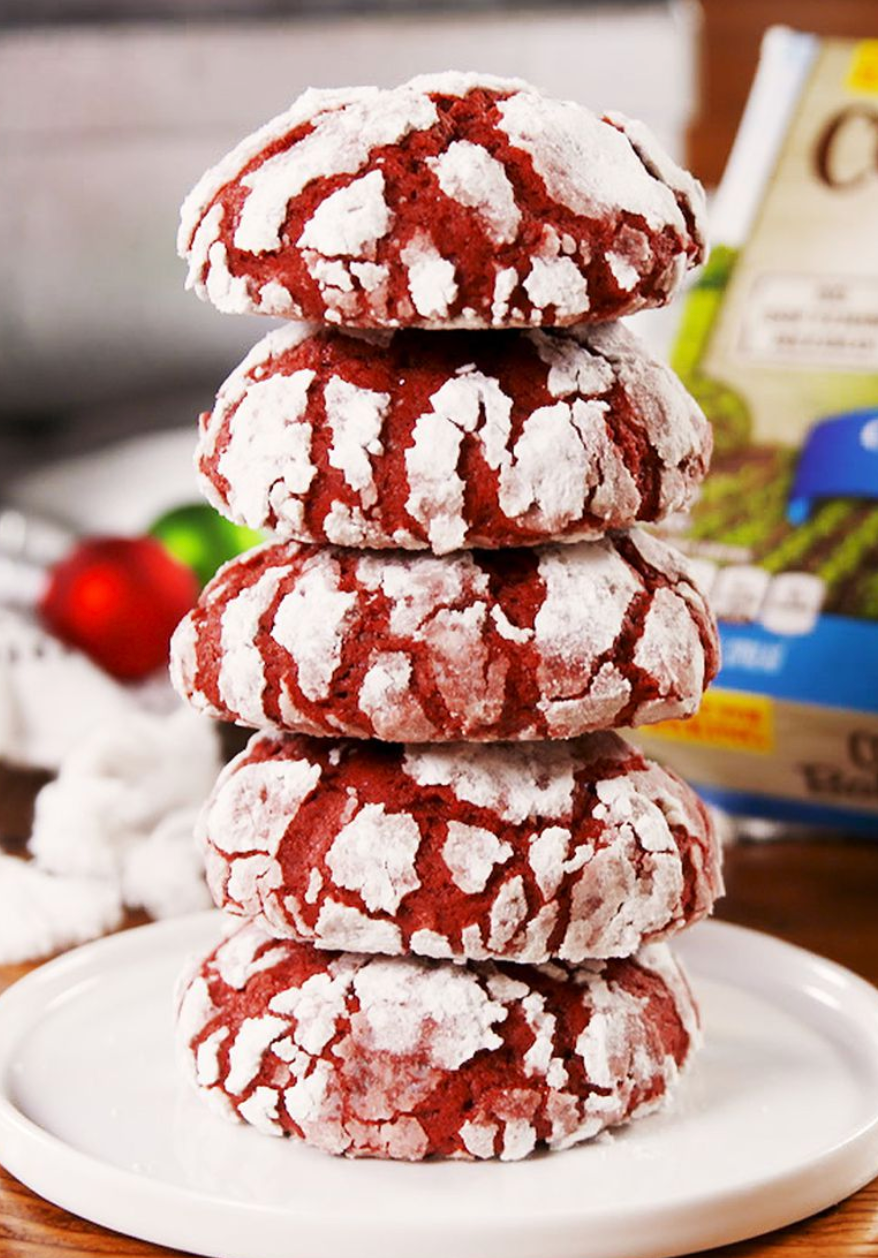 red velvet crinkle cookies stacked on white plate