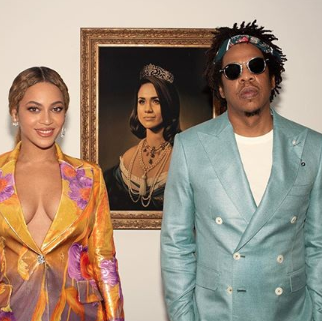 Beyonce and Jay-Z accept Brit Award in front of a portrait of Meghan Markle  as the Queen